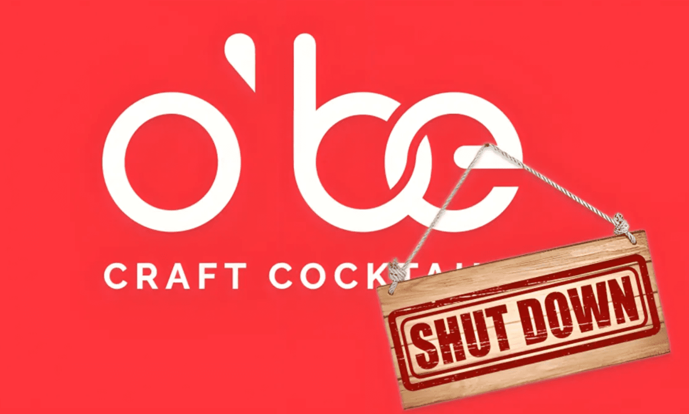 O'Be Cocktails product lineup against a rustic background with cocktail glasses